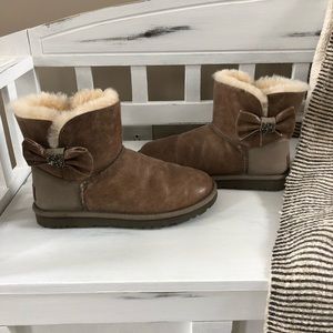Tan short Uggs with bows.